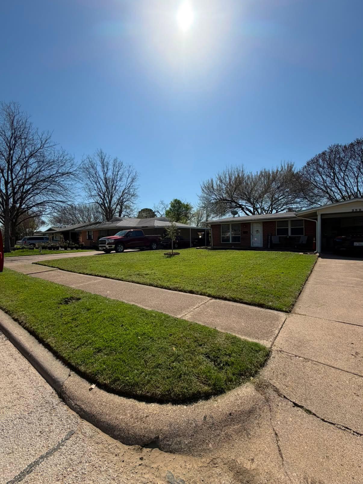 Ranch home front lawn mowing & precision edging — after
